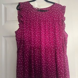 Magenta sleeveless tiered top with white polka dots.